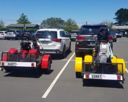 2 x Venture golf trikes on custom built matching trailers
